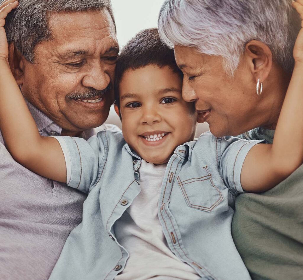 Child smiling with grandparents