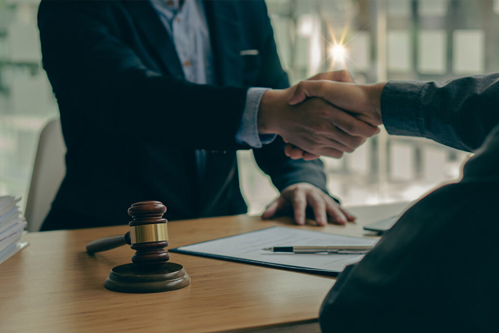 Lawyer and client shake hands