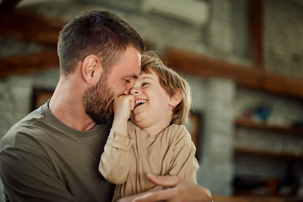 Happy boy playing with his dad.