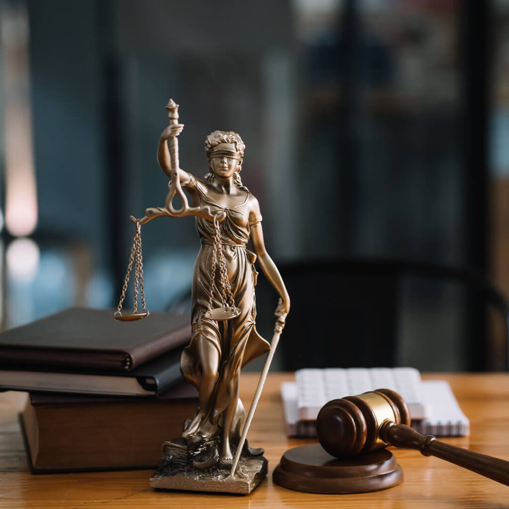 A justice statue and gavel on desk