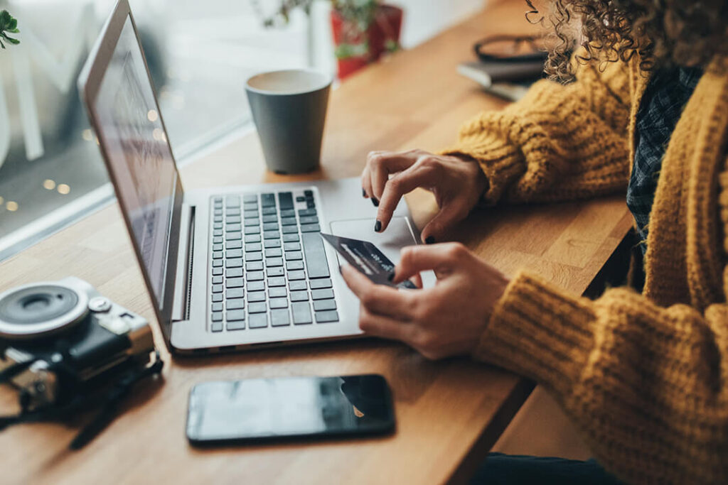 Woman paying online through her laptop